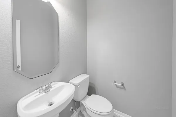 a white toilet sitting next to a bathroom sink