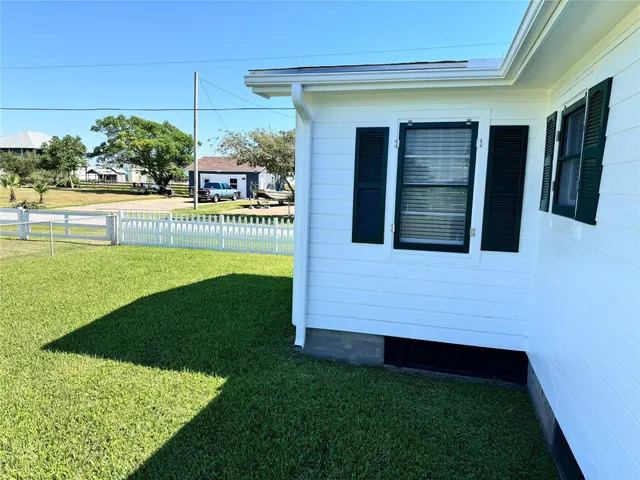 a view of an entrance to house with yard