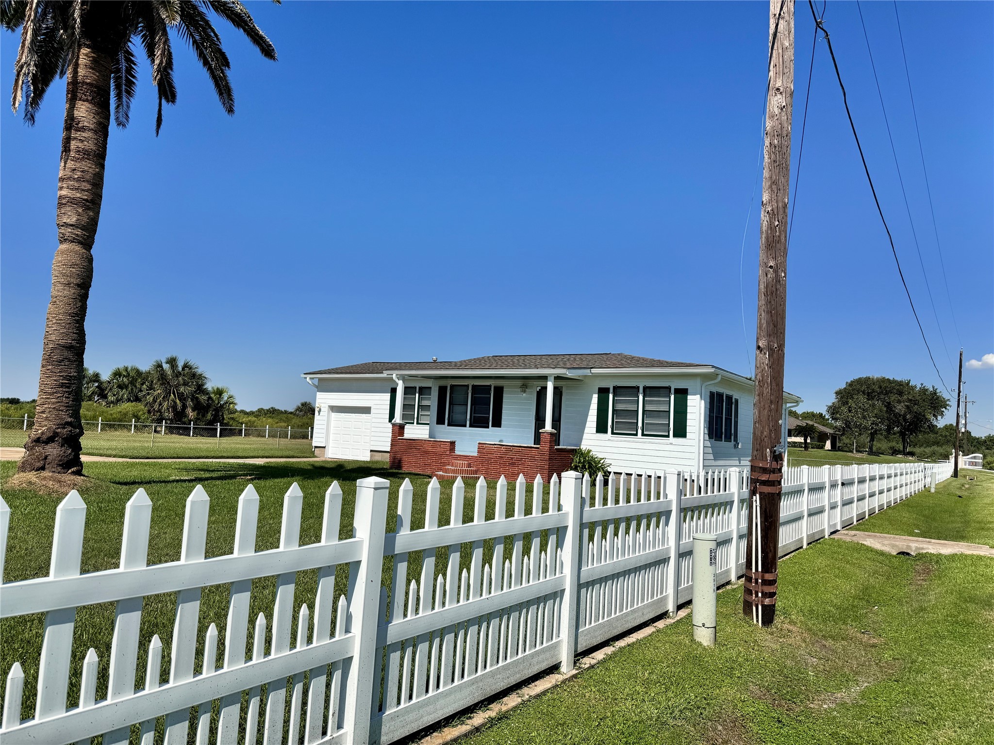 2515 Broome Road Galveston, TX 77554 - Photo 3 of 13 a front view of a house with a yard