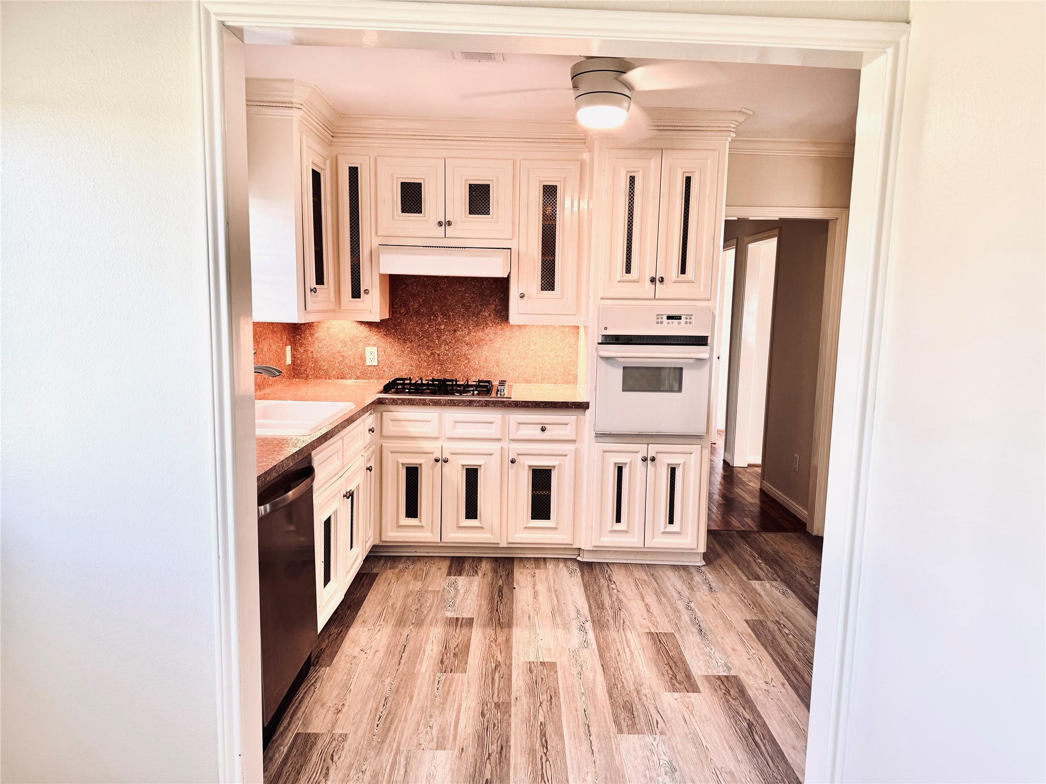 2515 Broome Road Galveston, TX 77554 - Photo 6 of 13 a large white kitchen with stainless steel appliances