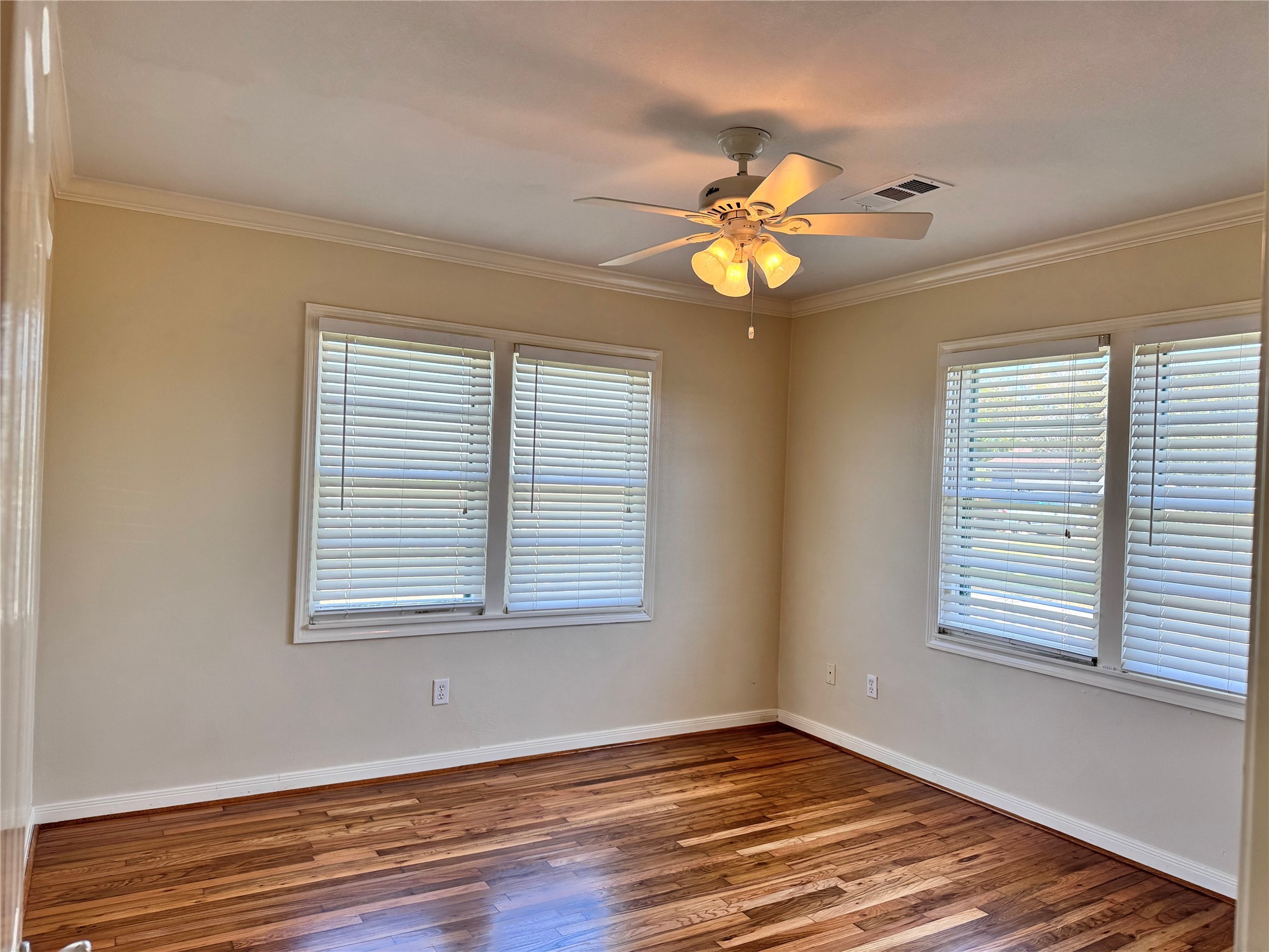 2515 Broome Road Galveston, TX 77554 - Photo 9 of 13 a view of an empty room with window and wooden floor