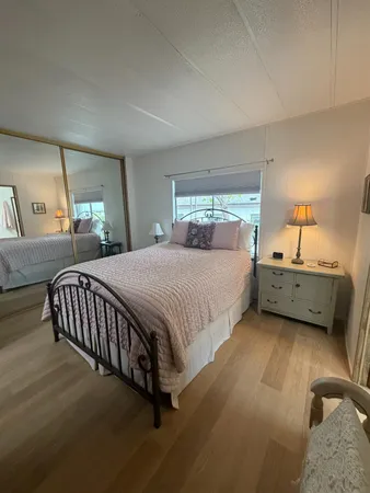 a spacious bedroom with a bed and a window