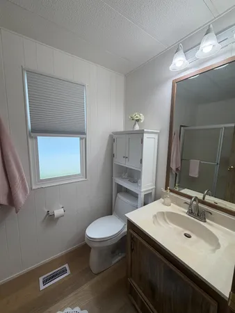 a bathroom with a sink toilet and mirror