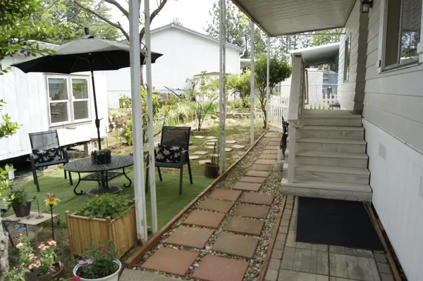 a view of a porch with chairs and backyard