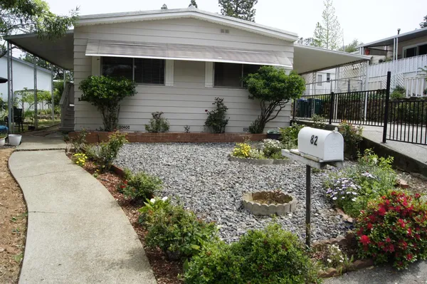 a front view of a house with garden