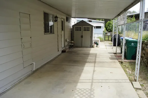 a view of a porch with a table and chairs