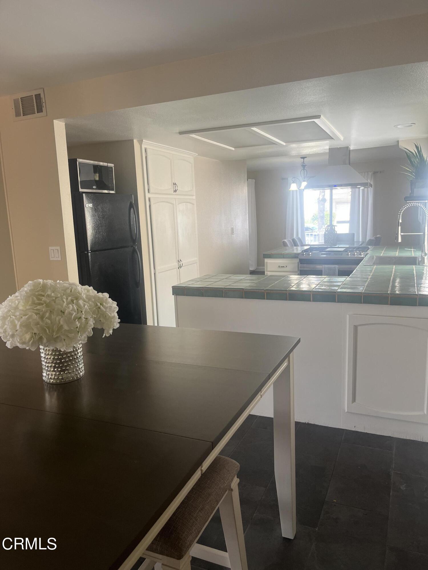 2065 Ironbark Drive Oxnard, CA 93036 - Photo 4 of 17 a kitchen with kitchen island a sink stove and refrigerator