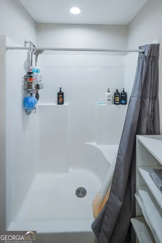 a bed sitting in a bedroom next to a window