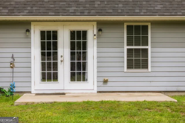 a living room with a bed furniture and a window