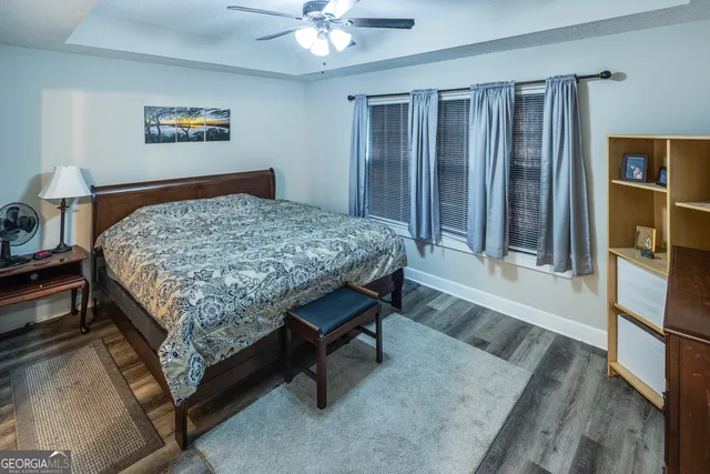 a bed sitting in a bedroom next to a window