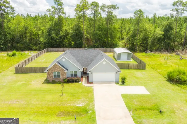 a view of swimming pool with lawn chairs and large trees