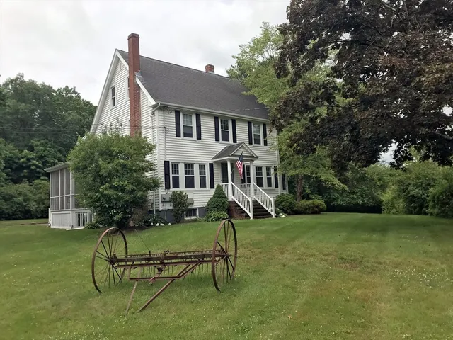a house view with a sitting space garden and bench