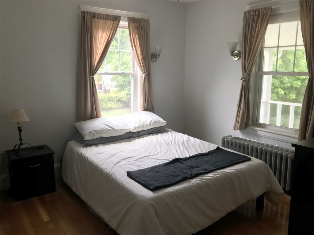 393 West Street, Unit 2 Walpole, MA 02081 - Photo 15 of 21 a bedroom with a bed and a window