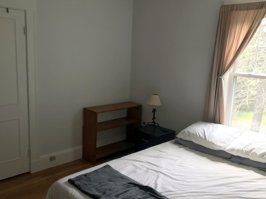 393 West Street, Unit 2 Walpole, MA 02081 - Photo 16 of 21 a bedroom with a bed and a window