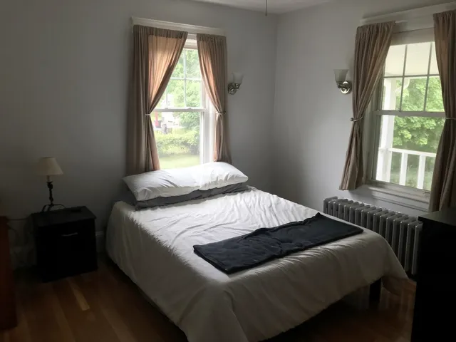 a bedroom with a bed and a window