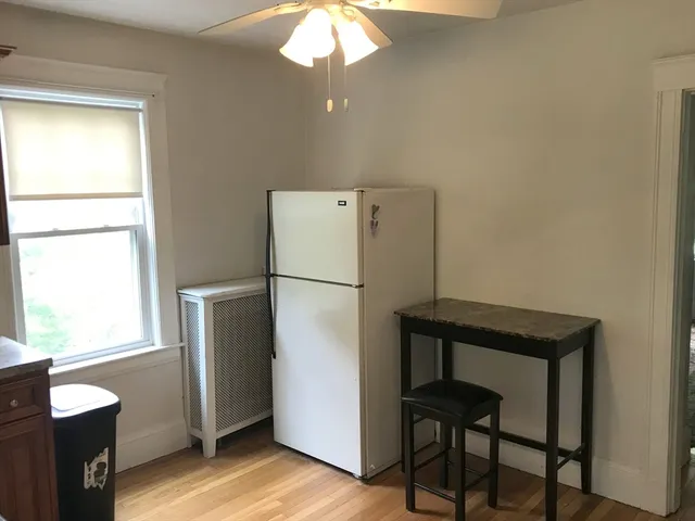 a kitchen with a refrigerator a stove and a window