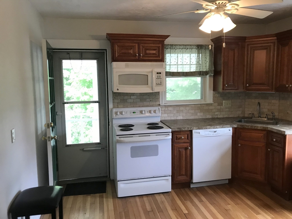 393 West Street, Unit 2 Walpole, MA 02081 - Photo 4 of 21 a kitchen with a stove a sink and a window