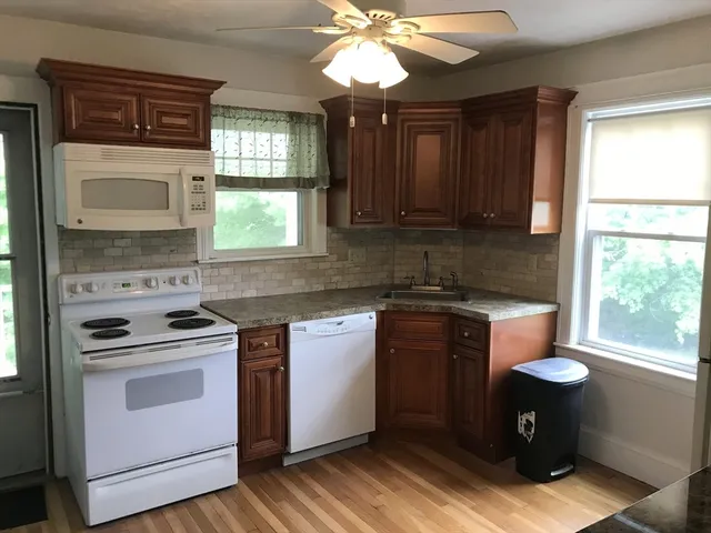 a kitchen with a stove a sink and a microwave