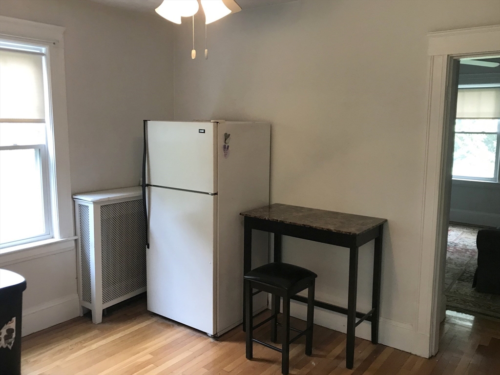 393 West Street, Unit 2 Walpole, MA 02081 - Photo 6 of 21 a white refrigerator freezer and a wooden floor