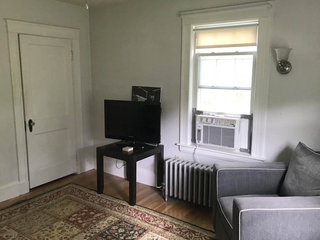 393 West Street, Unit 2 Walpole, MA 02081 - Photo 8 of 21 a living room with furniture and a flat screen tv