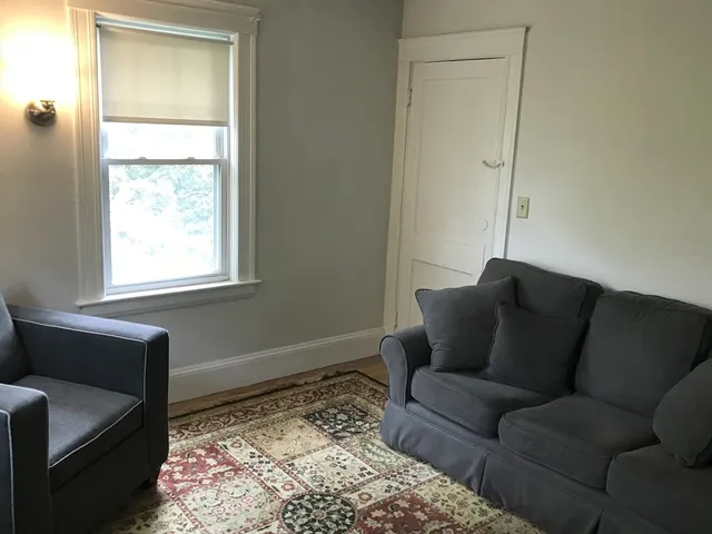 a living room with a couch and a window
