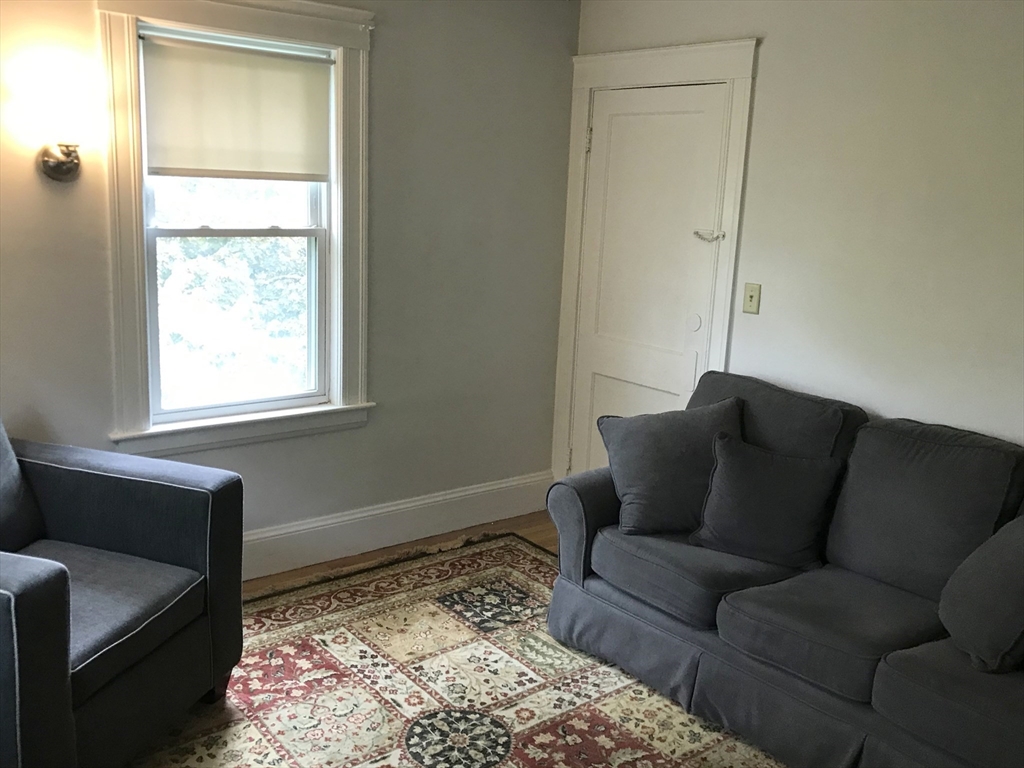 393 West Street, Unit 2 Walpole, MA 02081 - Photo 9 of 21 a living room with a couch and a window