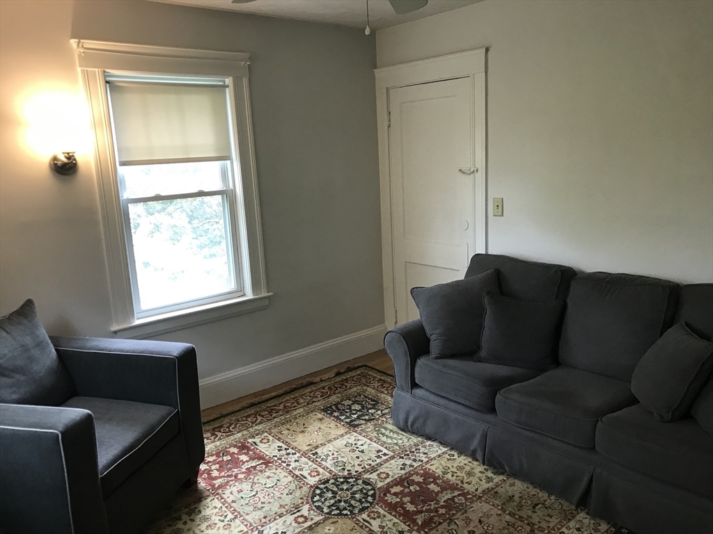 393 West Street, Unit 2 Walpole, MA 02081 - Photo 10 of 21 a living room with a couch and a window