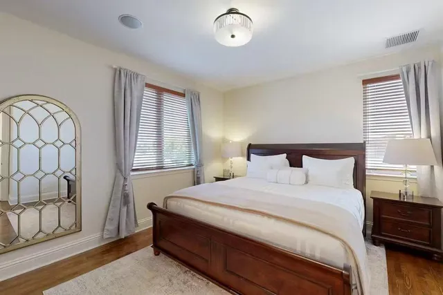 a bedroom with a bed and a mirror