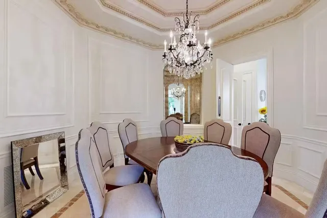 a view of a dining room with furniture and chandelier