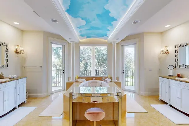 a view of spacious bathroom with dual sinks