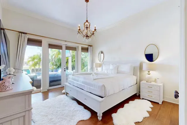 a spacious bedroom with a bed and a chandelier