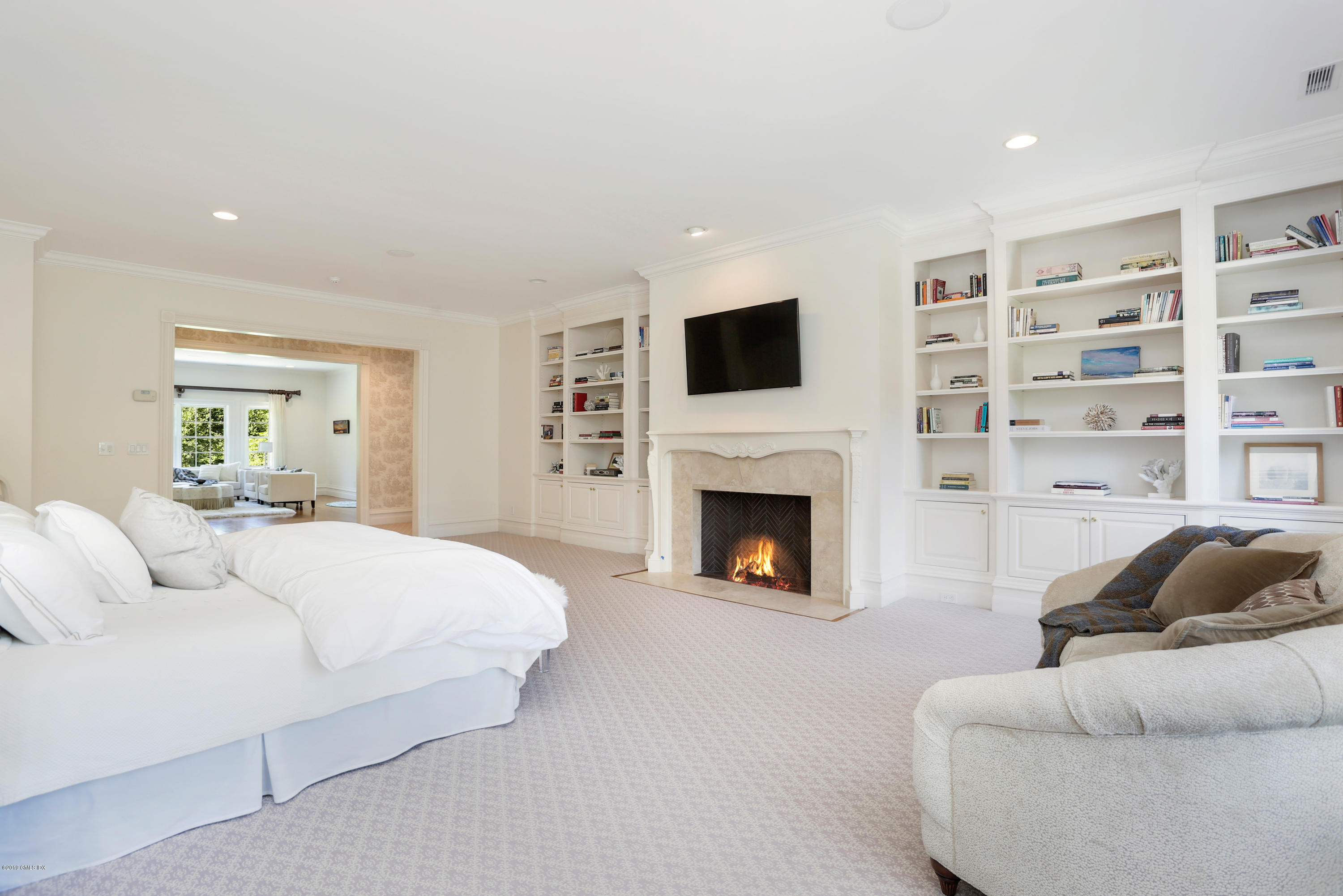 15 Knollwood Drive Greenwich, CT 06830 - Photo 12 of 30 a bedroom with a bed a fireplace and a window