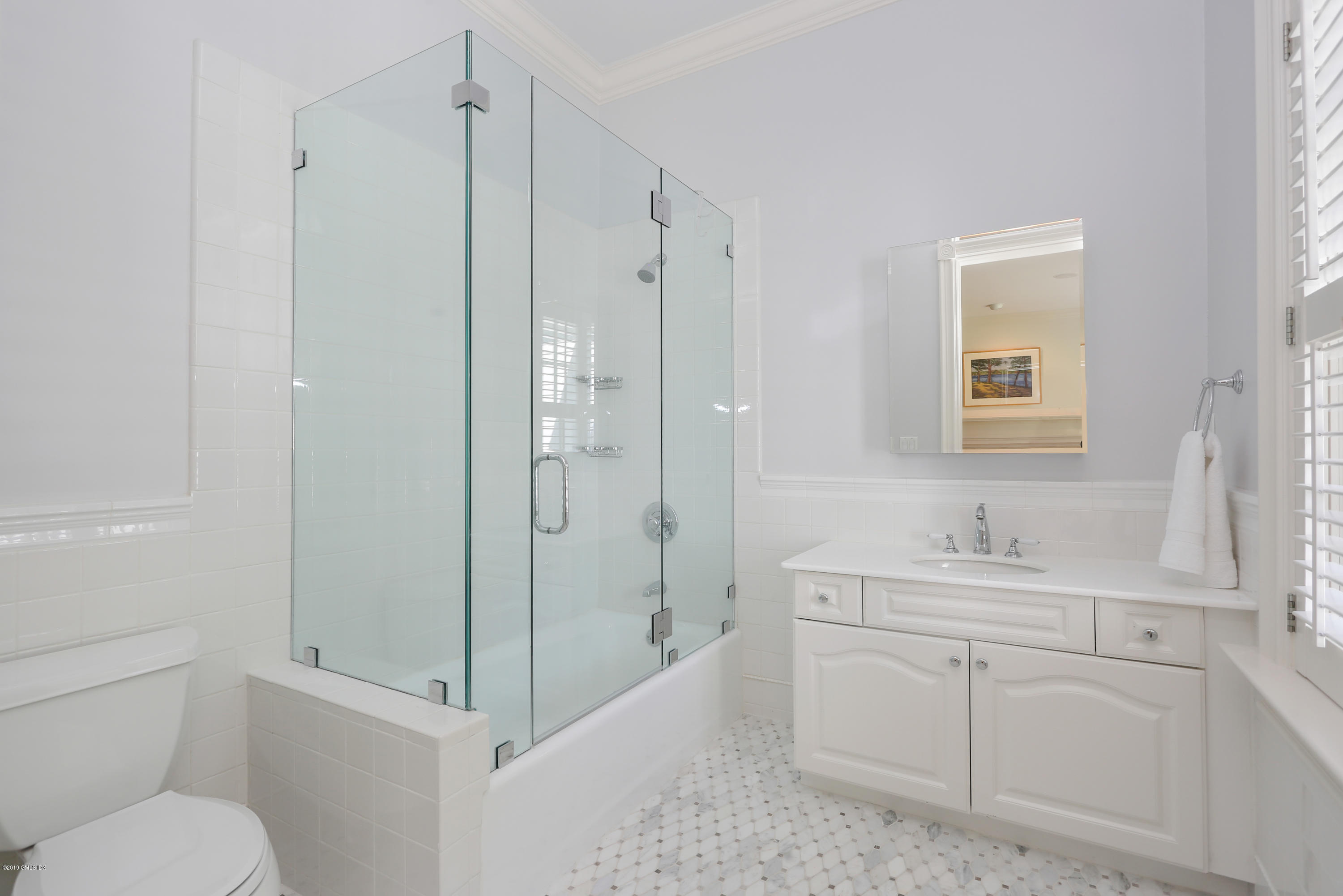 15 Knollwood Drive Greenwich, CT 06830 - Photo 19 of 30 a bathroom with a shower sink vanity mirror and toilet