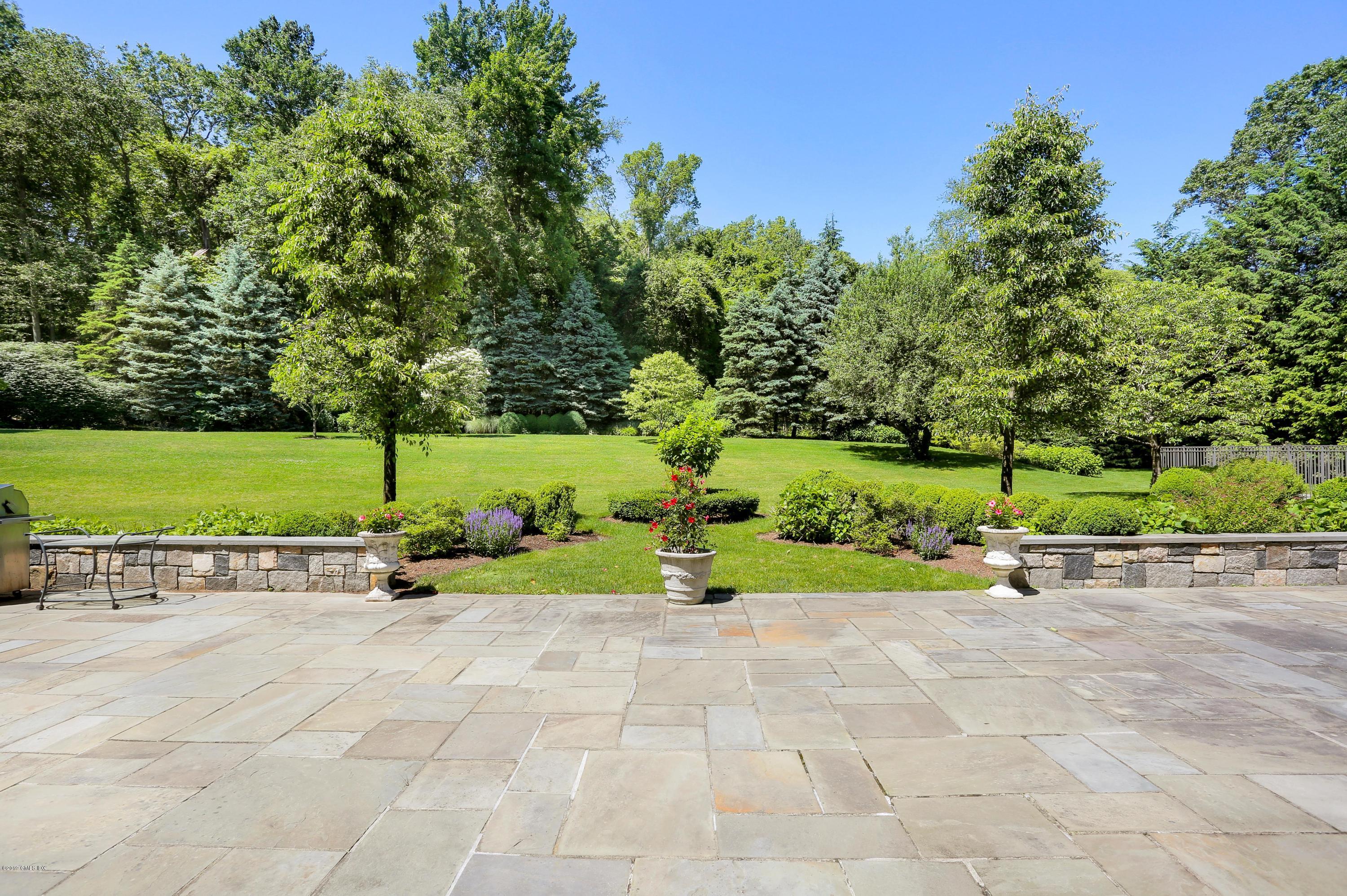 15 Knollwood Drive Greenwich, CT 06830 - Photo 28 of 30 a view of a garden with a bench