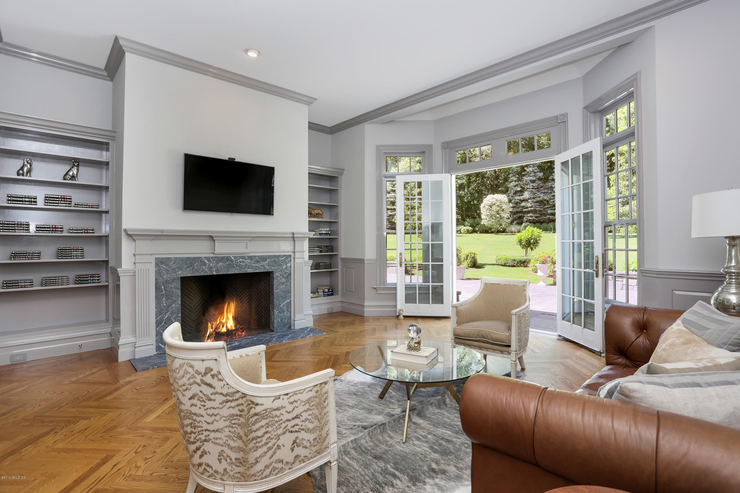 15 Knollwood Drive Greenwich, CT 06830 - Photo 10 of 30 a living room with furniture a flat screen tv and a fireplace