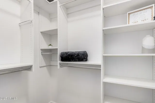 an empty room with windows and closet