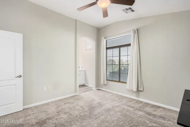 a view of a livingroom with a ceiling fan and a window