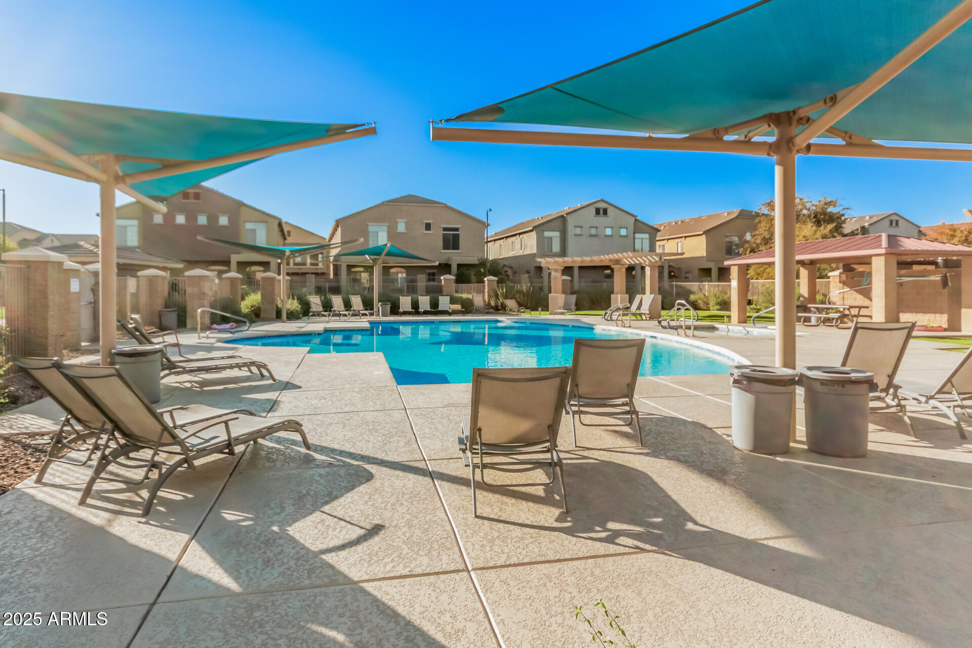 1350 South Greenfield Road, Unit 1046 Mesa, AZ 85206 - Photo 34 of 35 a view of a patio with table and chairs under an umbrella