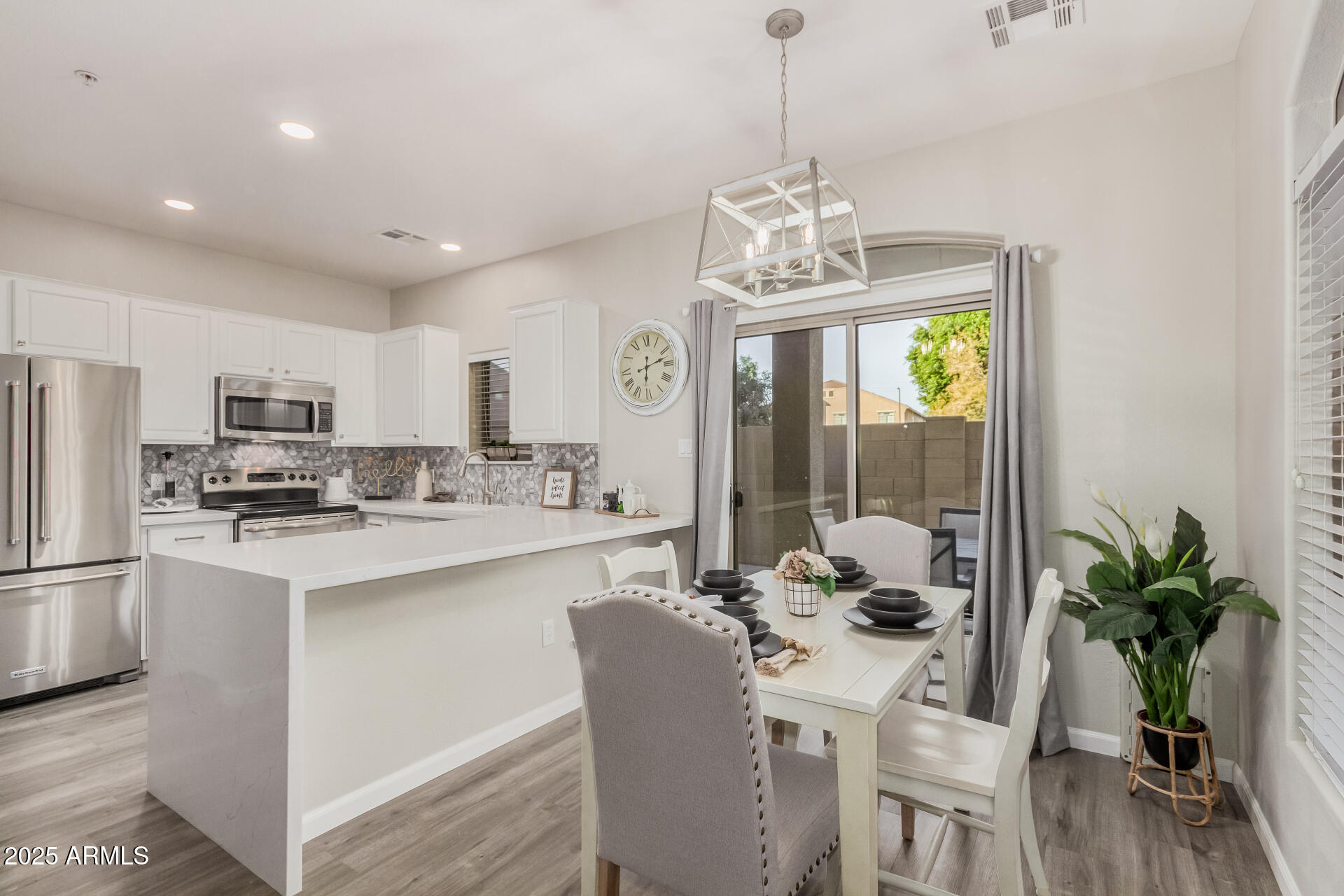 1350 South Greenfield Road, Unit 1046 Mesa, AZ 85206 - Photo 8 of 35 a view of a dining room with furniture a chandelier and wooden floor