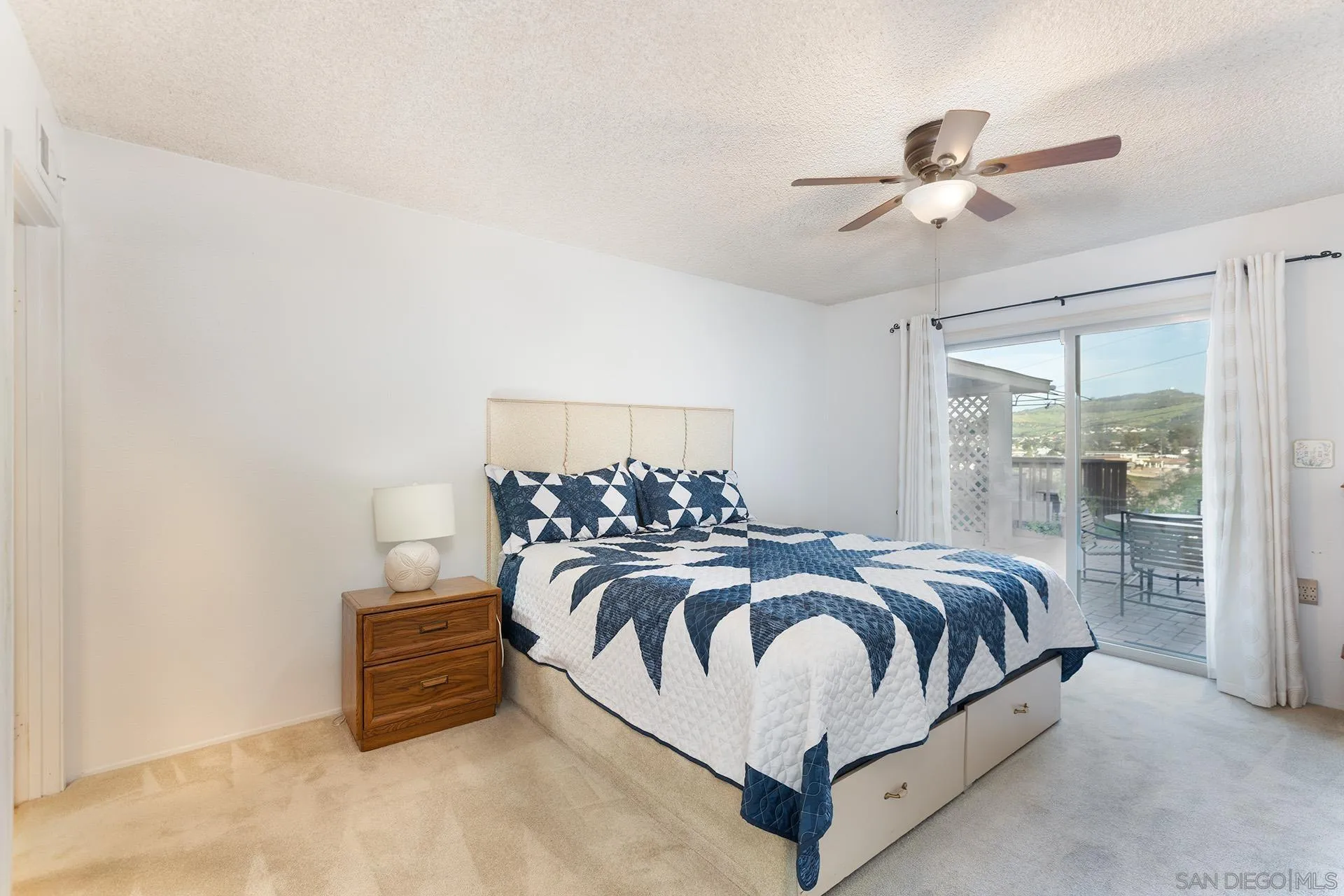 12455 Ridgeton Drive Lakeside, CA 92040 - Photo 12 of 31 a spacious bedroom with a bed and ceiling fan