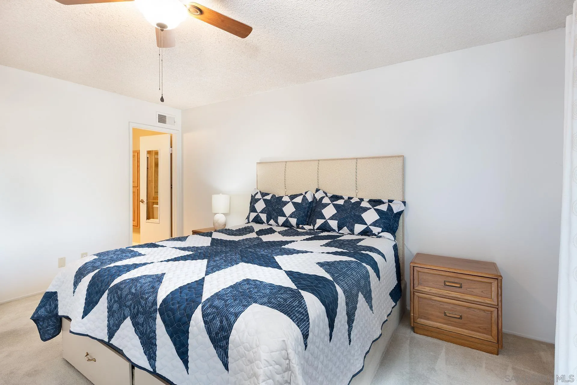 12455 Ridgeton Drive Lakeside, CA 92040 - Photo 14 of 31 a bed room with a bed and a chandelier