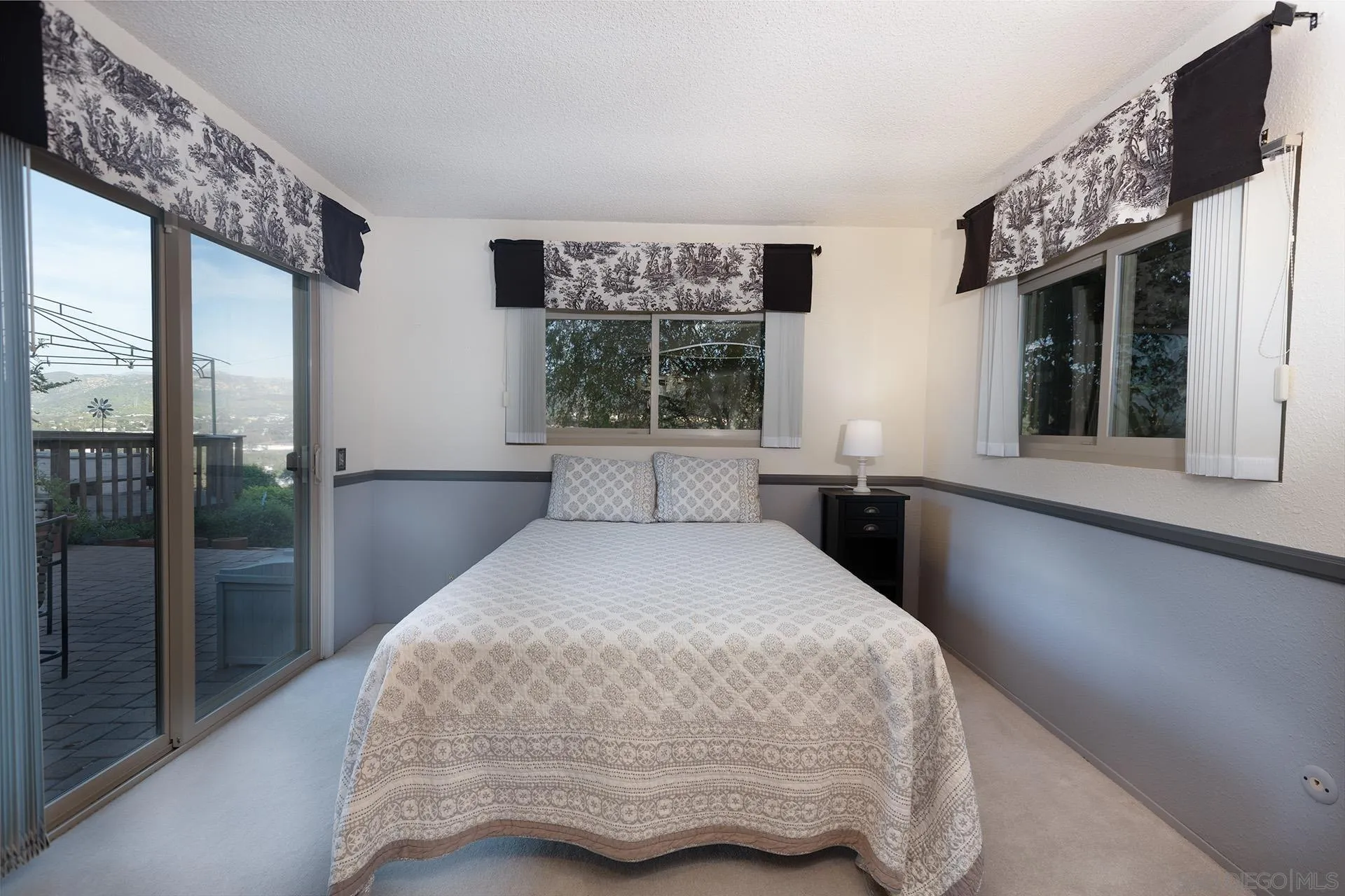 12455 Ridgeton Drive Lakeside, CA 92040 - Photo 17 of 31 a bedroom with a large bed and a window