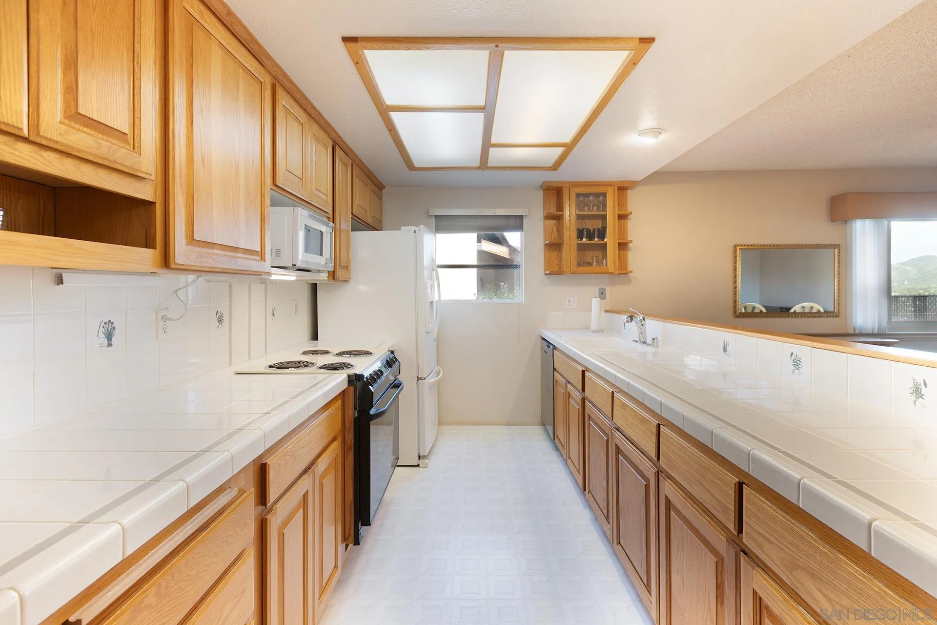 12455 Ridgeton Drive Lakeside, CA 92040 - Photo 6 of 31 a kitchen with stainless steel appliances granite countertop a sink and a stove