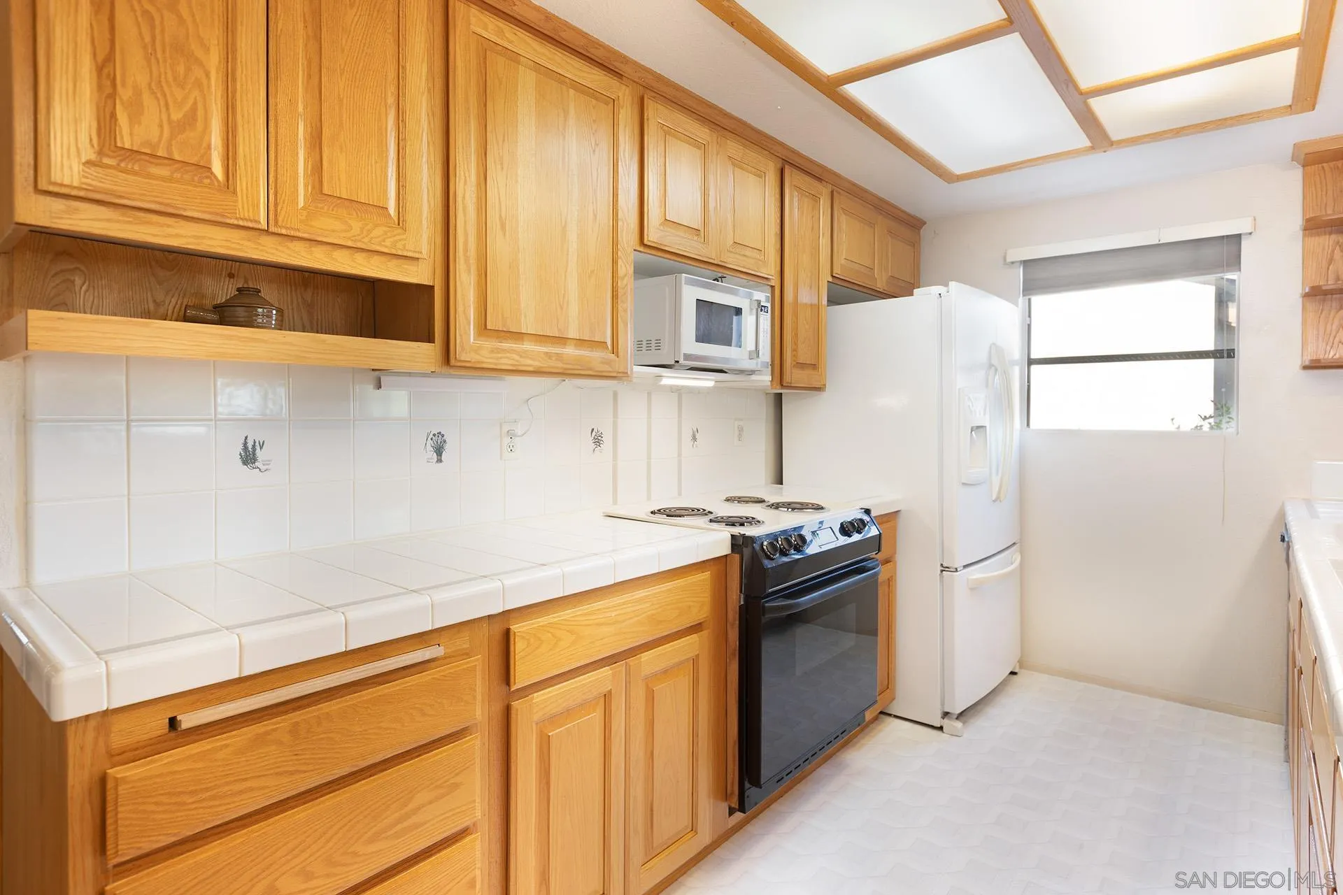 12455 Ridgeton Drive Lakeside, CA 92040 - Photo 7 of 31 a kitchen with stainless steel appliances granite countertop a refrigerator and a stove