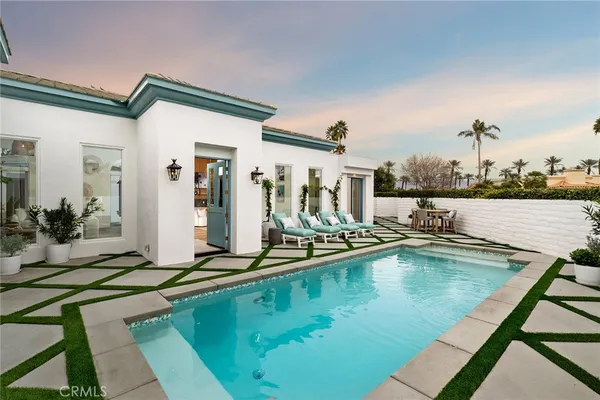 a view of a swimming pool with outdoor seating