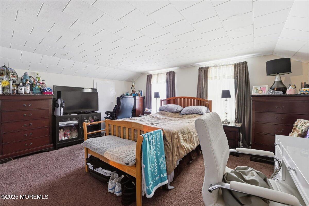 233 Broadway Union Beach, NJ 07735 - Photo 28 of 45 a bedroom with a bed and flat screen tv