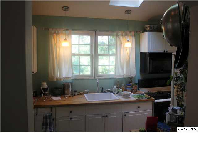 881 Ridge Street Charlottesville, VA 22902 - Photo 4 of 16 a kitchen with a sink stove and microwave