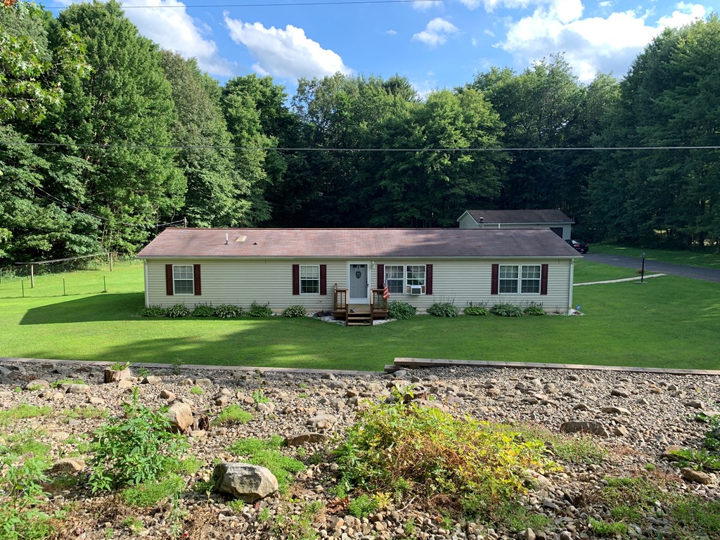 3870 Georgetown Road Polk, PA 16342 - Photo 2 of 42 a front view of a house with garden