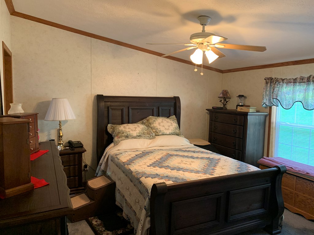 3870 Georgetown Road Polk, PA 16342 - Photo 25 of 42 a bedroom with a bed and a lamp on dresser