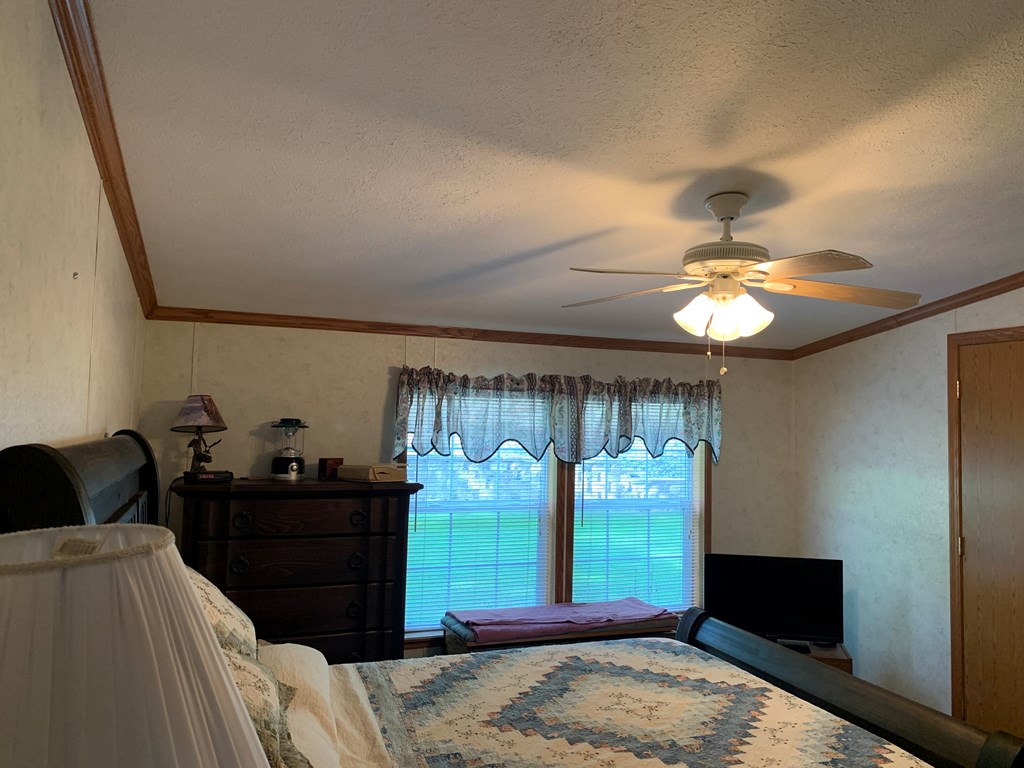 3870 Georgetown Road Polk, PA 16342 - Photo 26 of 42 a bedroom with a bed and a dresser